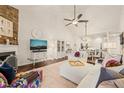 Bright living room features a cozy fireplace, elegant furnishings, and a view into the dining area at 63 Radcliffe Ct, Clayton, NC 27527