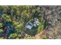 Bird's eye view of a home with mature trees, driveway and well maintained lawn at 65 Gentle Winds Dr, Chapel Hill, NC 27517
