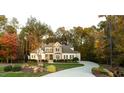 Beautiful, tree-lined property showcasing a meticulously maintained lawn and stone accents at 7004 Bartons Bend Way, Raleigh, NC 27614