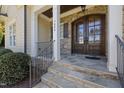 Covered front porch featuring elegant columns and a beautiful stone facade at 7004 Bartons Bend Way, Raleigh, NC 27614