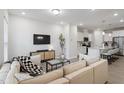 Bright, open living room with modern decor and a seamless flow to the kitchen at 814 Silo Park Dr, Wake Forest, NC 27587