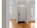 Bright foyer with hardwood floors, neutral walls, and an elegant entry door in this beautifully staged home at 909 Edgewater Cir, Chapel Hill, NC 27516