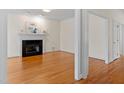 Elegant living room with hardwood floors, a fireplace, and neutral walls, ready for personalization at 909 Edgewater Cir, Chapel Hill, NC 27516
