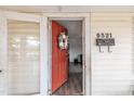 Inviting front door with wreath, open to reveal a glimpse of the living room with hardwood floors at 9321 Stephenson Adams Ln, Willow Springs, NC 27592