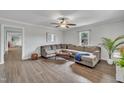 Spacious living room with hardwood floors, large sectional couch, and plenty of natural light at 9321 Stephenson Adams Ln, Willow Springs, NC 27592