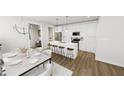 Bright kitchen with an island, barstool seating, stainless appliances, and a modern dining area at 934 Allen Park Dr, Knightdale, NC 27604