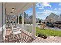 Inviting front porch featuring classic white columns and a pair of comfortable rocking chairs at 100 Maywood Way, Chapel Hill, NC 27516