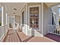 Cozy front porch showcasing classic columns and two comfortable rocking chairs, perfect for relaxing at 100 Maywood Way, Chapel Hill, NC 27516