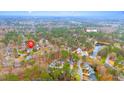 Expansive aerial view showcasing the home's location near a lake and pool surrounded by lush trees at 112 Parkmeadow Dr, Cary, NC 27519