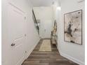 Inviting entryway featuring wood floors, white walls, and stylish decor at 1205 Coral Cay Bnd, Wake Forest, NC 27587