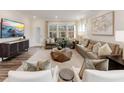 Bright living room with ample seating, large windows, and neutral decor, perfect for relaxation at 1205 Coral Cay Bnd, Wake Forest, NC 27587