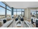 Open concept living room showcasing large windows with cityscape views and contemporary furniture at 122 N Harrington St # 1025, Raleigh, NC 27603