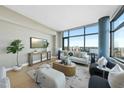 Bright living room features a large window with expansive city views and modern decor at 122 N Harrington St # 1025, Raleigh, NC 27603