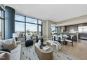 Stylish living room with floor-to-ceiling windows, an open floor plan, and a modern kitchen at 122 N Harrington St # 1025, Raleigh, NC 27603