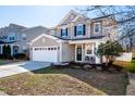 Two-story home with a front yard featuring lawn and mulched flower beds at 174 Coalyard Dr, Garner, NC 27529