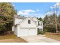 Classic white two-story home with a two-car garage and a well-maintained lawn at 201 New Timber Path, Apex, NC 27502
