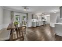 Open-concept kitchen and dining area with hardwood floors and ample natural light at 202 Brook Ln, Durham, NC 27712
