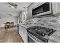 Modern kitchen featuring stainless steel appliances, granite countertops, and stylish backsplash at 202 Brook Ln, Durham, NC 27712