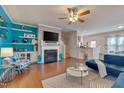 Bright living room with a fireplace, built-in shelves, and comfortable seating at 211 Brier Crossings Loop, Durham, NC 27703