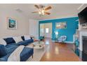 Spacious living room featuring a blue accent wall and a fireplace at 211 Brier Crossings Loop, Durham, NC 27703