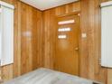 Entryway with wood-paneling and modern front door at 2116 Mckinney St, Burlington, NC 27217