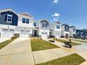 New townhomes with garages and modern farmhouse exterior design details and landscaping at 26 Twin Birch Dr, Angier, NC 27501