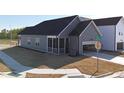 Rear exterior featuring a screened porch, a garage, a sidewalk, and landscaping at 273 Marvel Dr # 139, Rolesville, NC 27571