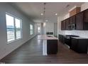 An open-concept kitchen featuring a stylish island, stainless steel appliances, and hardwood floors at 273 Marvel Dr # 139, Rolesville, NC 27571