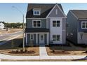 Aesthetic two-story home with gray siding, white trim, and well-manicured landscaping at 2880 Quarry Rd # 163, Rolesville, NC 27571