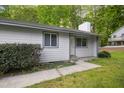 Quaint single-story house featuring light gray horizontal siding and updated windows trimmed in gray at 292 Cedar Lake Rd # A, Chapel Hill, NC 27516