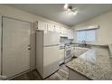 Bright kitchen featuring white appliances, granite countertops, and ample cabinet space at 292 Cedar Lake Rd # A, Chapel Hill, NC 27516
