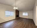 Spacious living room with wood-look flooring, brick fireplace, and lots of natural light at 292 Cedar Lake Rd # A, Chapel Hill, NC 27516