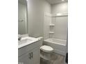 Bathroom features a vanity with white cabinets and a shower-tub combination with a white surround at 3011 Honeymyrtle Ln, Durham, NC 27703