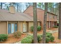 Inviting home exterior with neutral siding, a cozy entrance, and mature landscaping at 308 Summerfield Crossing Road, Chapel Hill, NC 27514