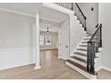 Spacious foyer features hardwood floors, staircase with decorative railing and an open floorplan at 309 Neuse Ridge Dr, Clayton, NC 27527