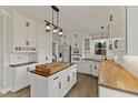 Well-lit kitchen boasts wood countertops, stainless steel appliances and pendant lighting at 309 Neuse Ridge Dr, Clayton, NC 27527