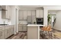 Bright, eat-in kitchen with stainless steel appliances, island with barstool seating, and wood flooring at 347 Canyon Spring Trl, Wake Forest, NC 27587