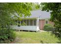 Cozy screened porch attached to a brick home, offering an inviting outdoor living space at 3560 Nc 98, Youngsville, NC 27596