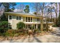 Charming front exterior featuring a well-maintained lawn, stone accents, and a two-car garage at 402 Westwood Dr, Chapel Hill, NC 27516