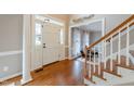 Inviting foyer with hardwood floors, white trim, and staircase leading to the second floor at 415 King George Loop, Cary, NC 27511
