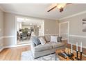 Cozy living room featuring hardwood floors, neutral paint, and an open view to the kitchen at 415 King George Loop, Cary, NC 27511