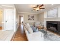 Comfortable living room with a fireplace, hardwood floors, and plenty of natural light at 415 King George Loop, Cary, NC 27511