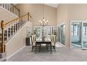 Elegant dining room with a chandelier, tall ceilings, and sliding glass doors at 42 Renwick Ct, Raleigh, NC 27615