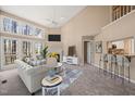 Bright living room featuring a fireplace, tall windows, and an open floor plan at 42 Renwick Ct, Raleigh, NC 27615