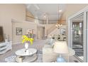 Spacious living room with an open floor plan, staircase, and view of the dining area at 42 Renwick Ct, Raleigh, NC 27615