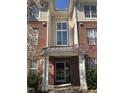 Welcoming entrance to a residential building featuring a well-lit doorway and a modern glass door with large window above at 421 Glencrest Pl, Chapel Hill, NC 27514