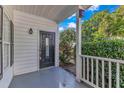 Charming front porch showcasing a black front door with decorative glass accents at 4622 Vendue Range Dr, Raleigh, NC 27604