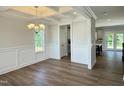 Dining room with wood floors adjoins the kitchen and features coffered ceiling and wainscoting at 511 Valentine Ct, Graham, NC 27253