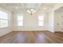 Bright dining room with coffered ceilings, paneled walls, hardwood floors, and ample natural light at 511 Valentine Ct, Graham, NC 27253