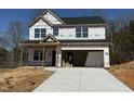 Unfinished construction shows a two-story home with a garage and newly poured driveway at 511 Valentine Ct, Graham, NC 27253